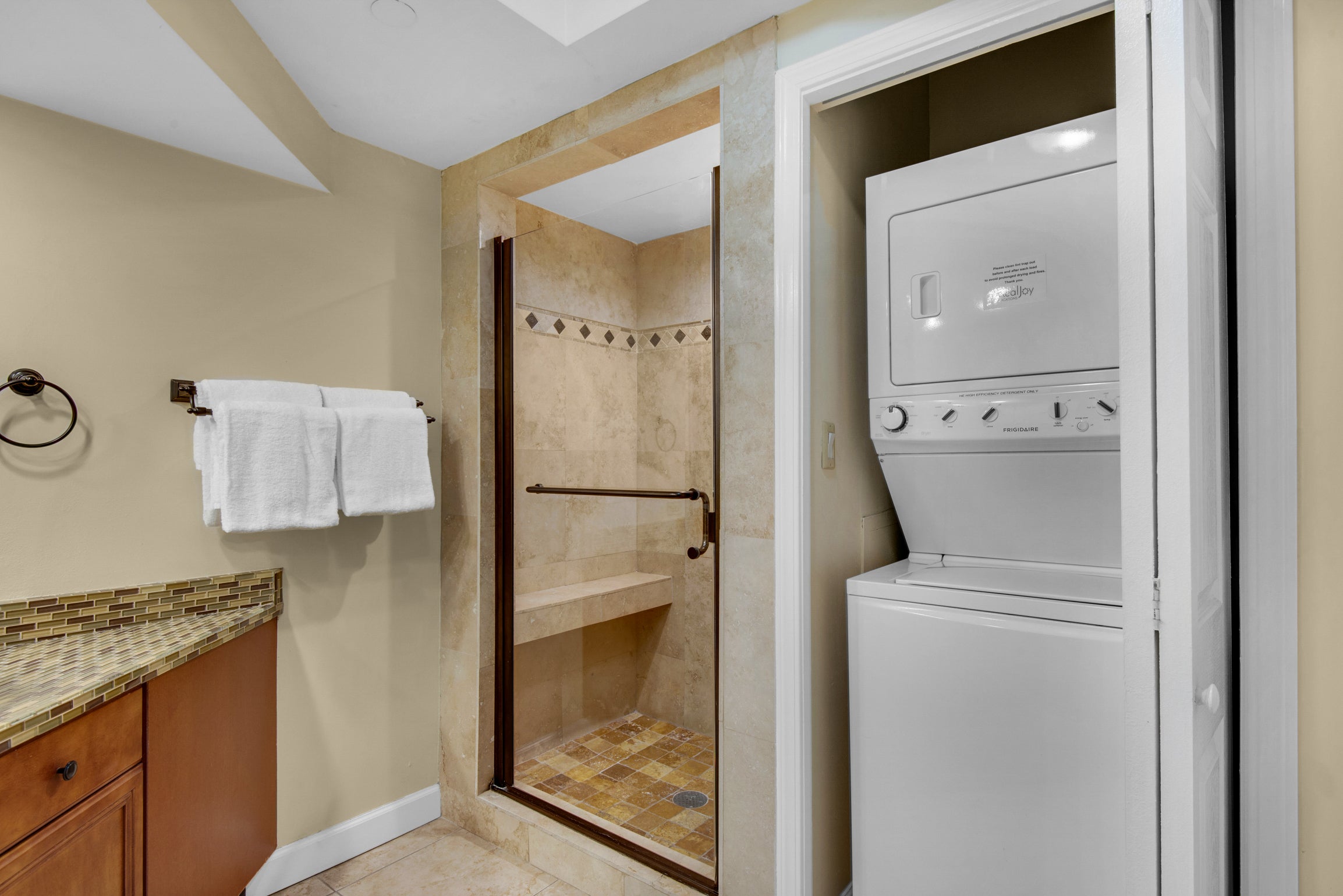 Master shower next to washer and dryer