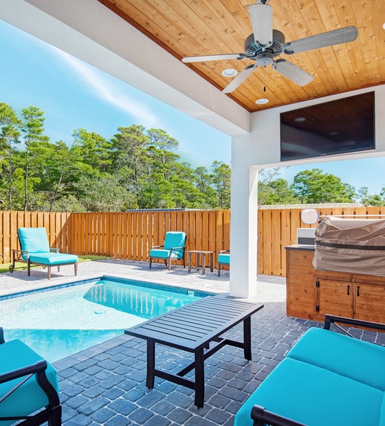 Large back patio with propane and charcoal grills and Flatscreen TV