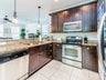 Kitchen w/ granite and stainless steel appliances