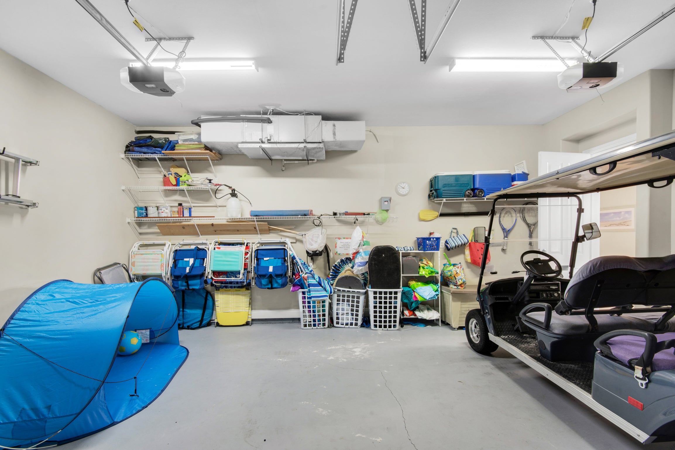 Garage with Golf Cart and beach gear
