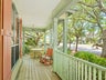 Relaxing porch with ocean breezes shaded by oaks
