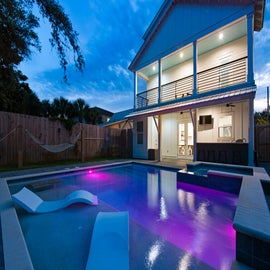 Backyard Oasis with colorful pool lights