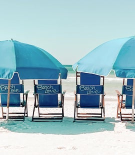Beach chairs with umbrellas 