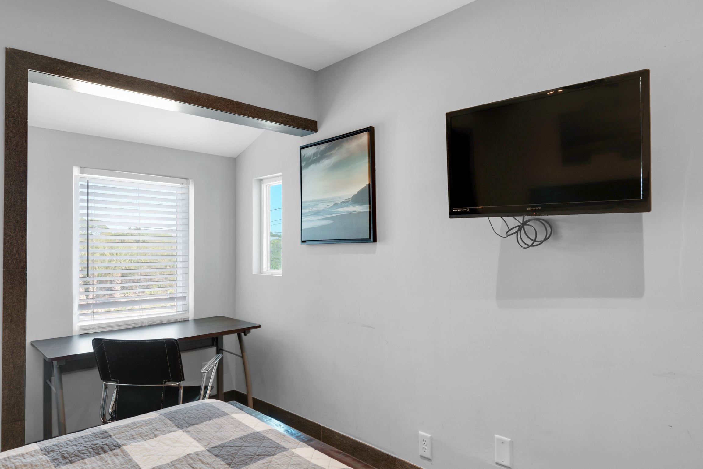 Guest bedroom with flat screen TV and desk
