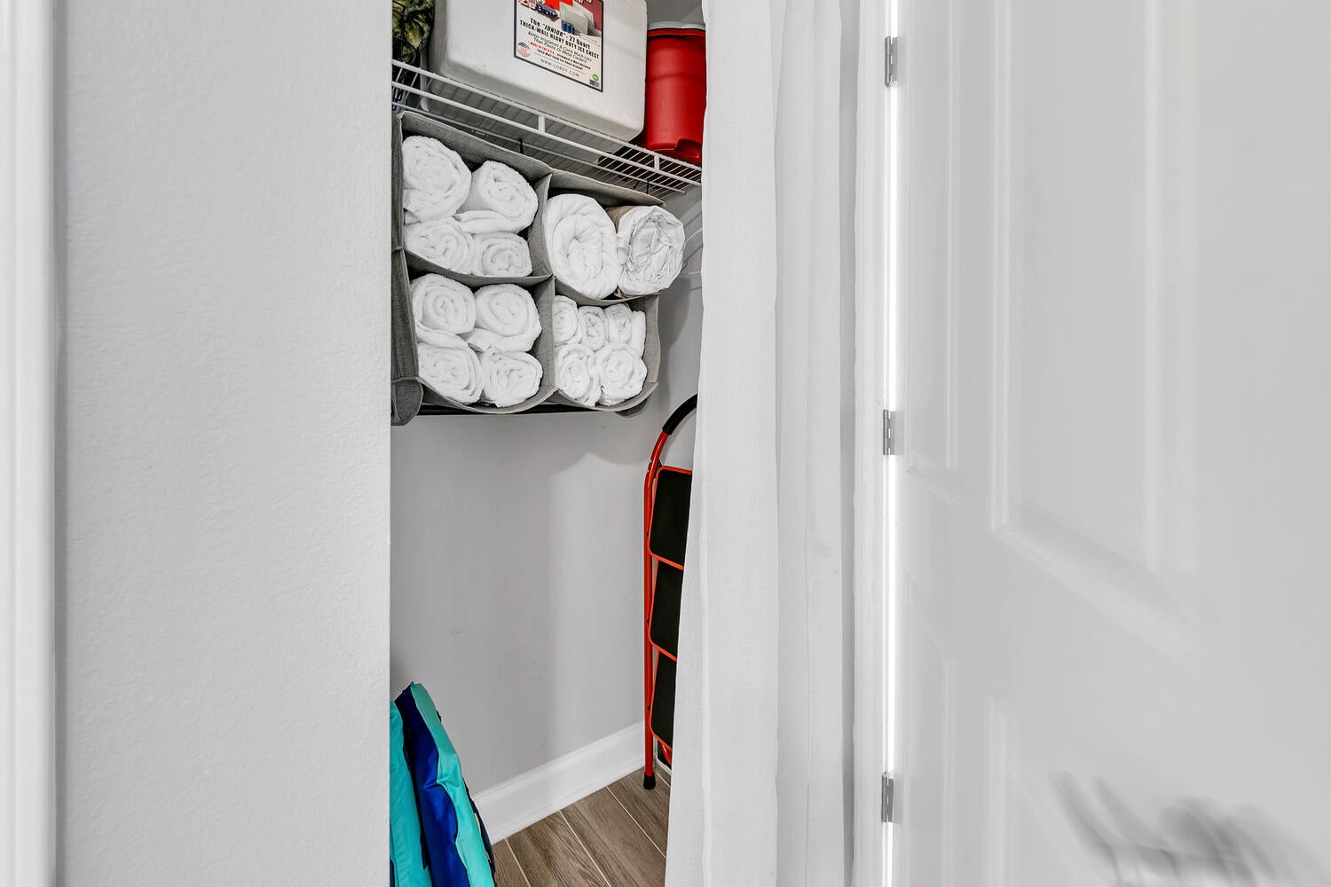 Closet with towels and beach supplies
