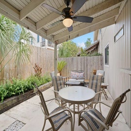 Covered private patio with tropical foliage