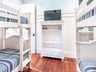Bunk room with two bunk beds and flat screen TV
