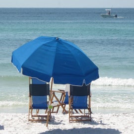 There is an empty beach chair waiting for you