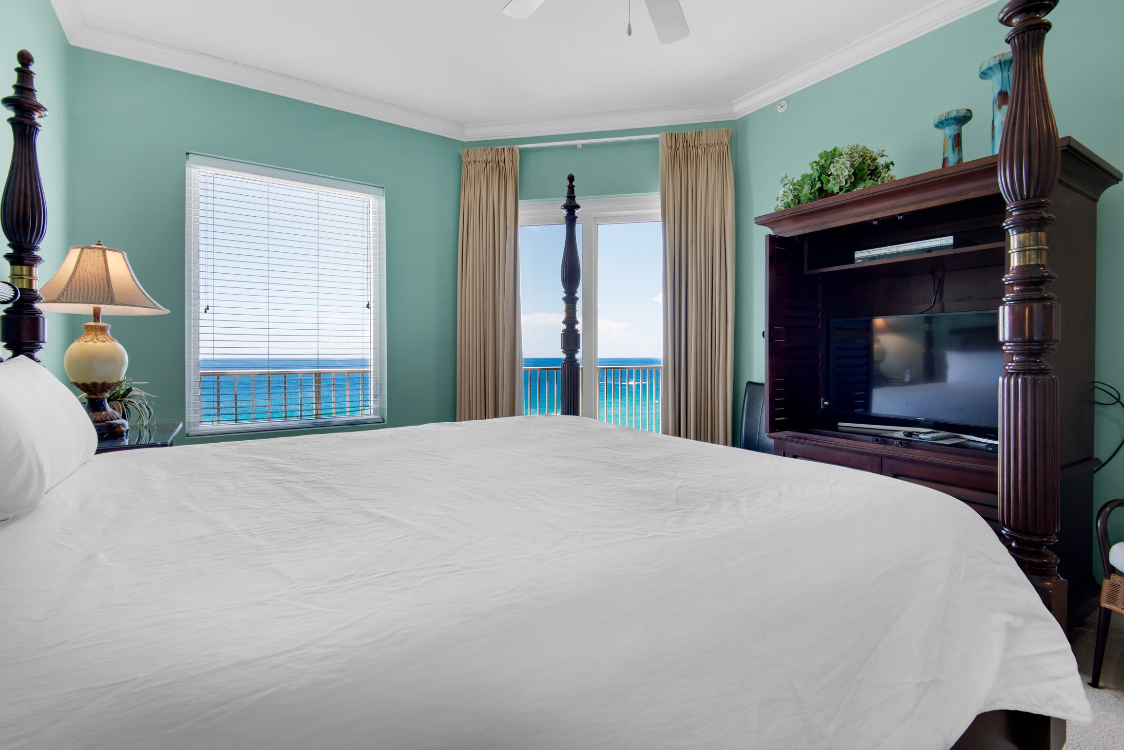 Master bedroom with balcony access and flat screen