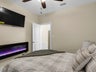Guest bedroom with LED fireplace and TV