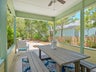 Covered outdoor dining area with ceiling fan