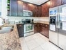 Kitchen w/ granite and stainless steel appliances