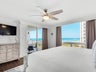 Master bedroom with balcony access and a view