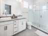 Massive shower, dual sinks and modern finishes