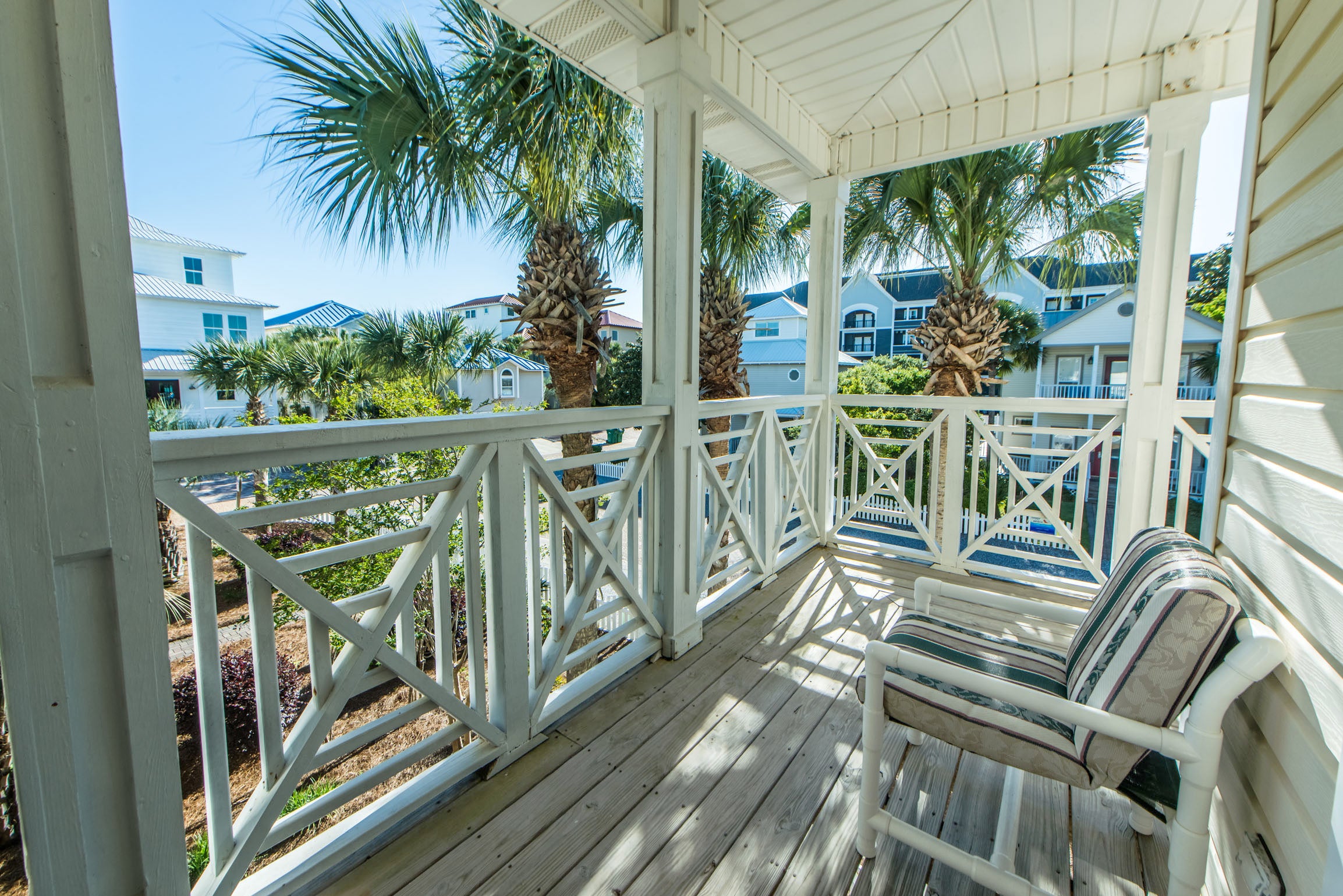 Welcoming Covered Porch shaded by Palms