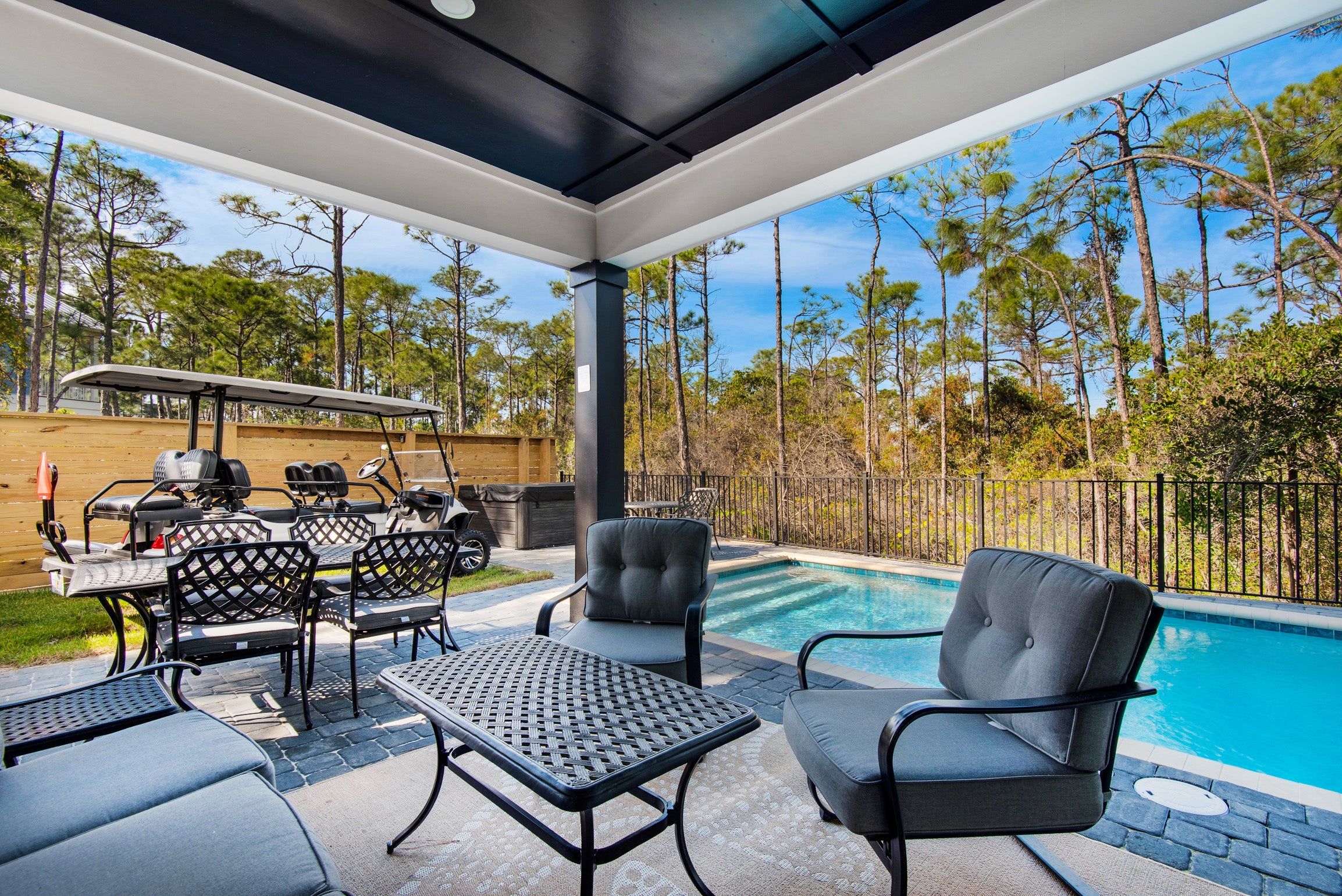 Relax on the back patio by the pool and hot tub