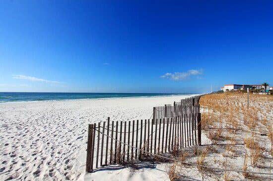 Beach, blue sky, and beach fence